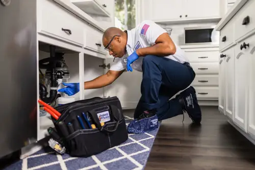 Trevor from Benjamin Franklin working under a sink in a kitchen Can I do hydro jetting myself? 